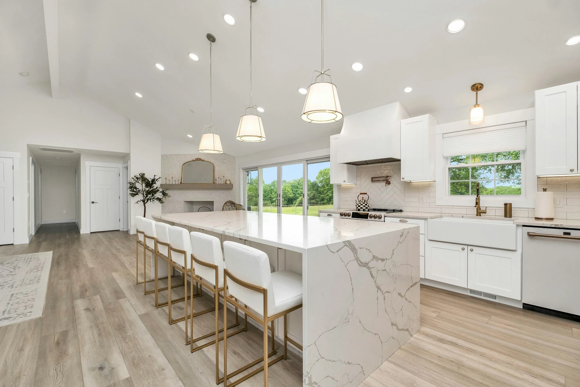 Kitchen with a marble island and white cabinets