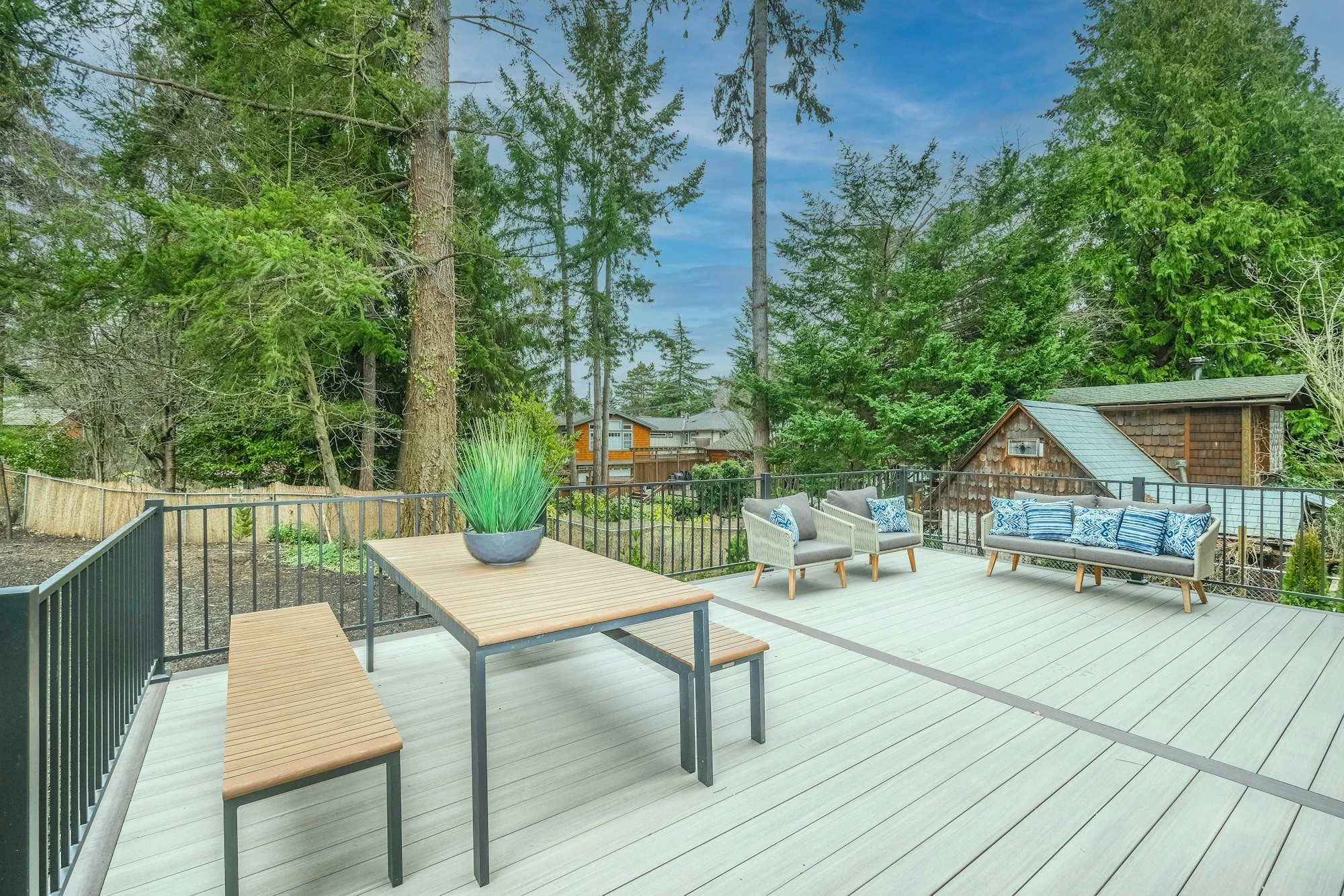 Backyard wood deck with outdoor dining set