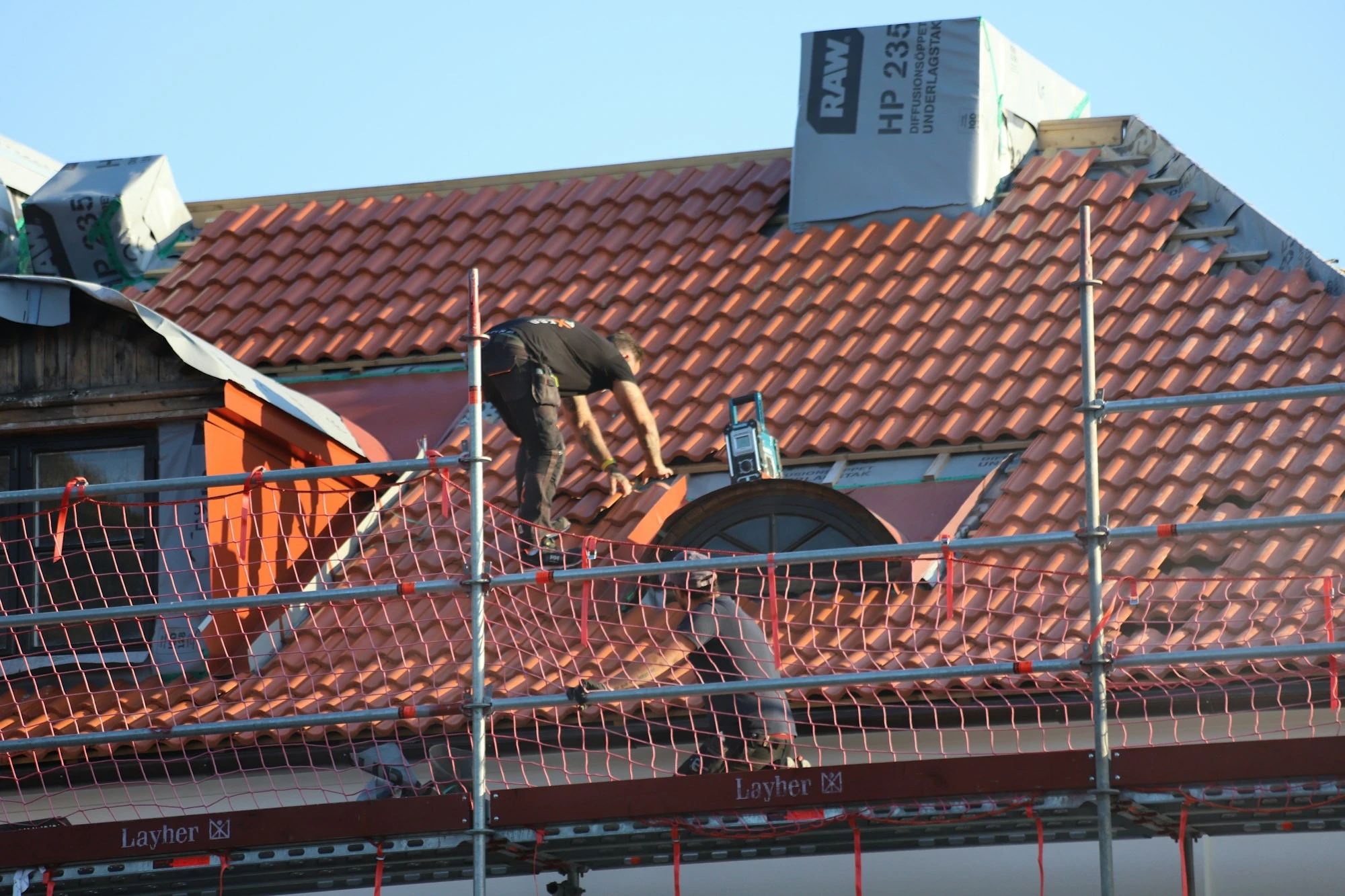 Roofer working on a residential roof in Polk County