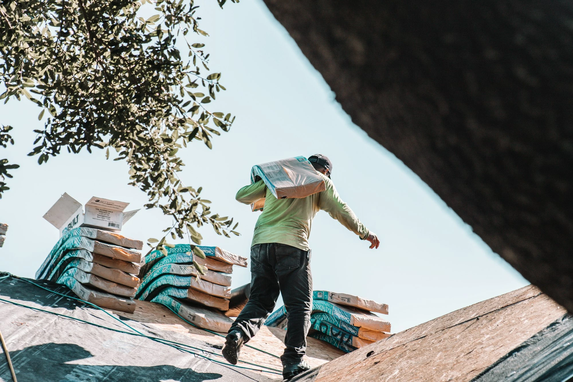 Roofer carrying shingles during a roof replacement in Lakeland