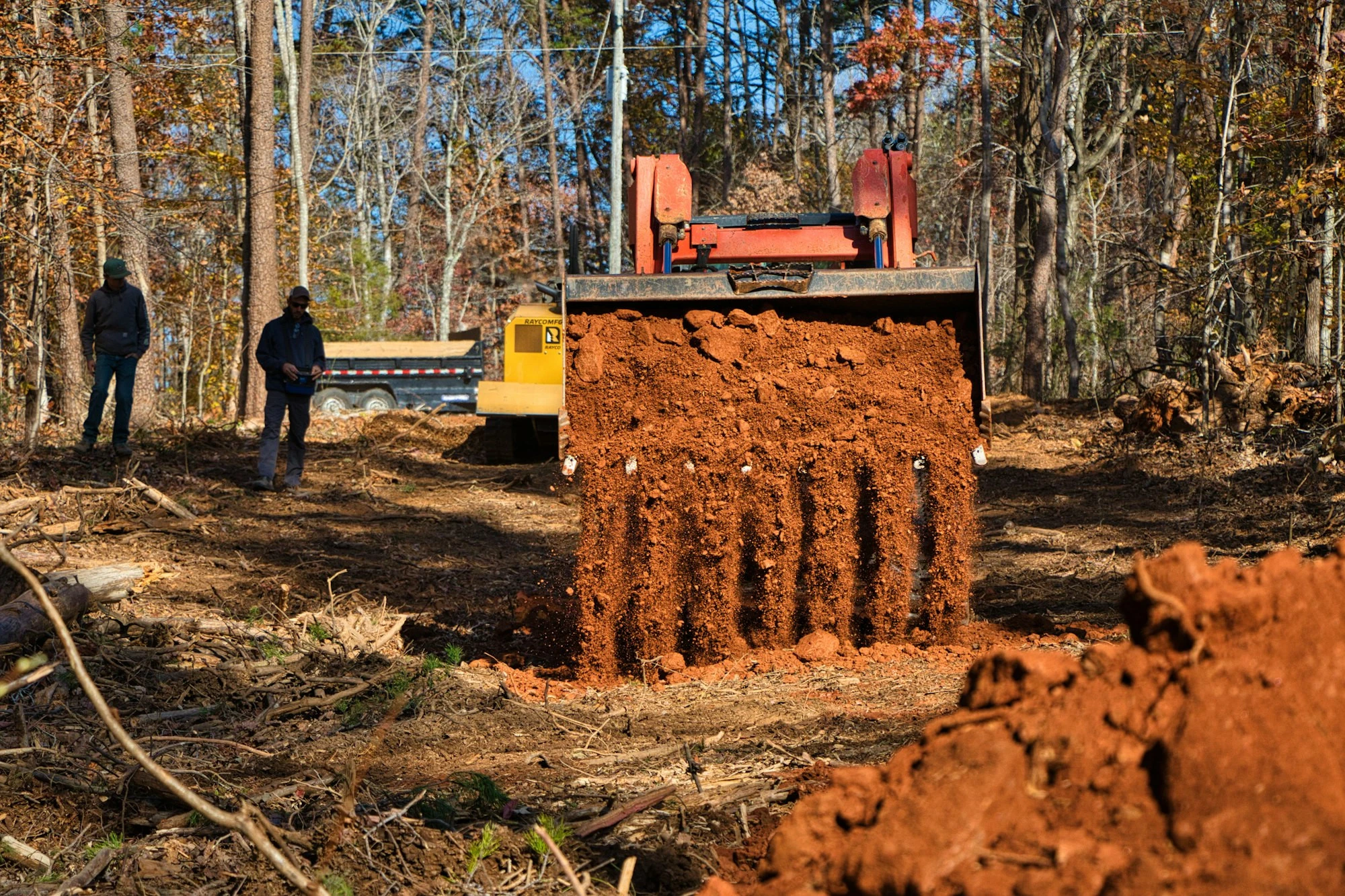 Excavator digging footings on a residential construction site
