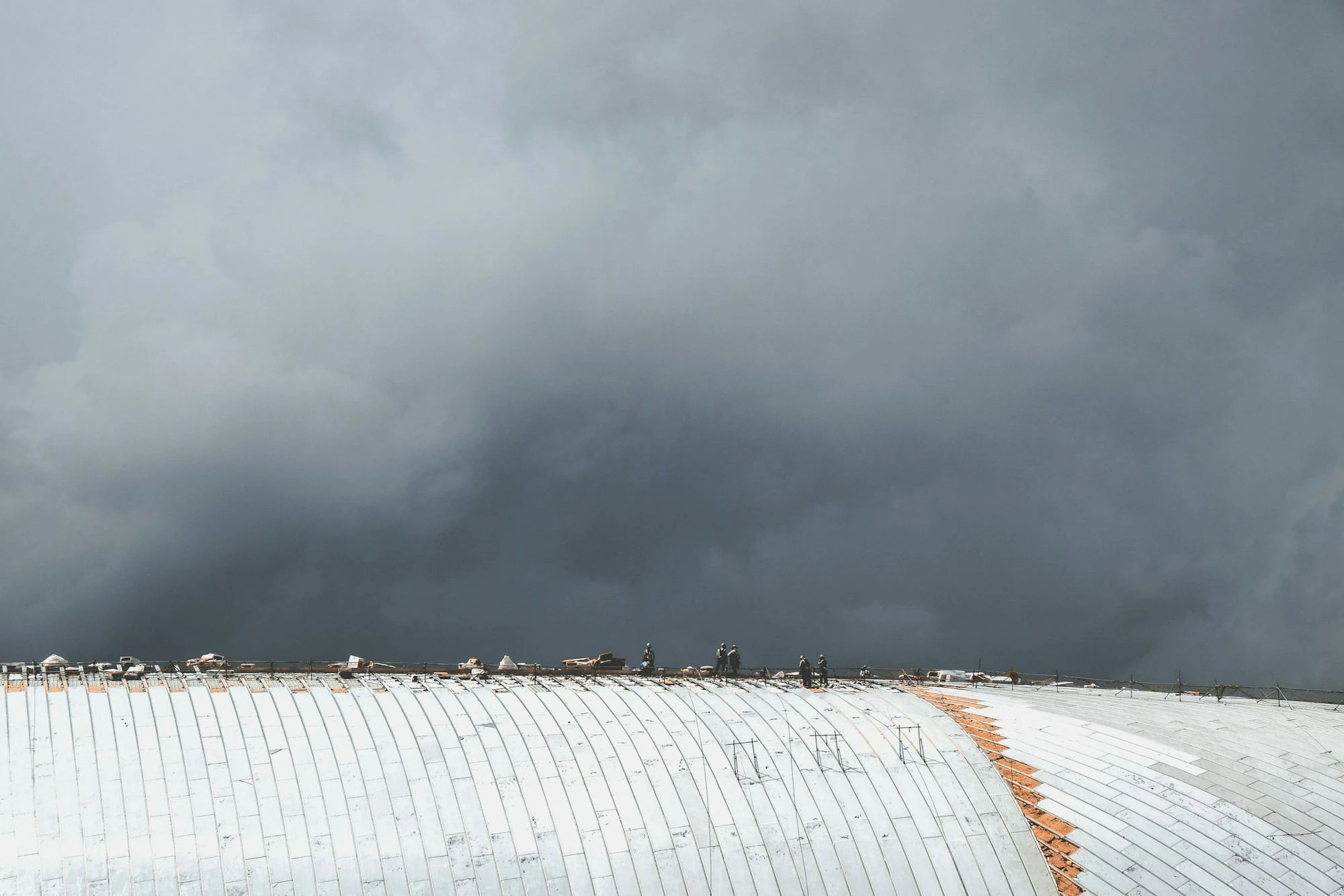 Crew inspecting a low-slope roof for leaks