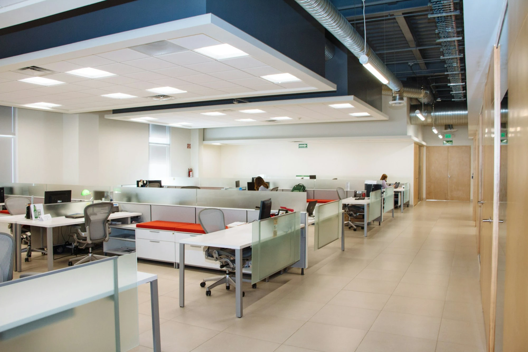 Office interior with white desks and frosted glass partitions