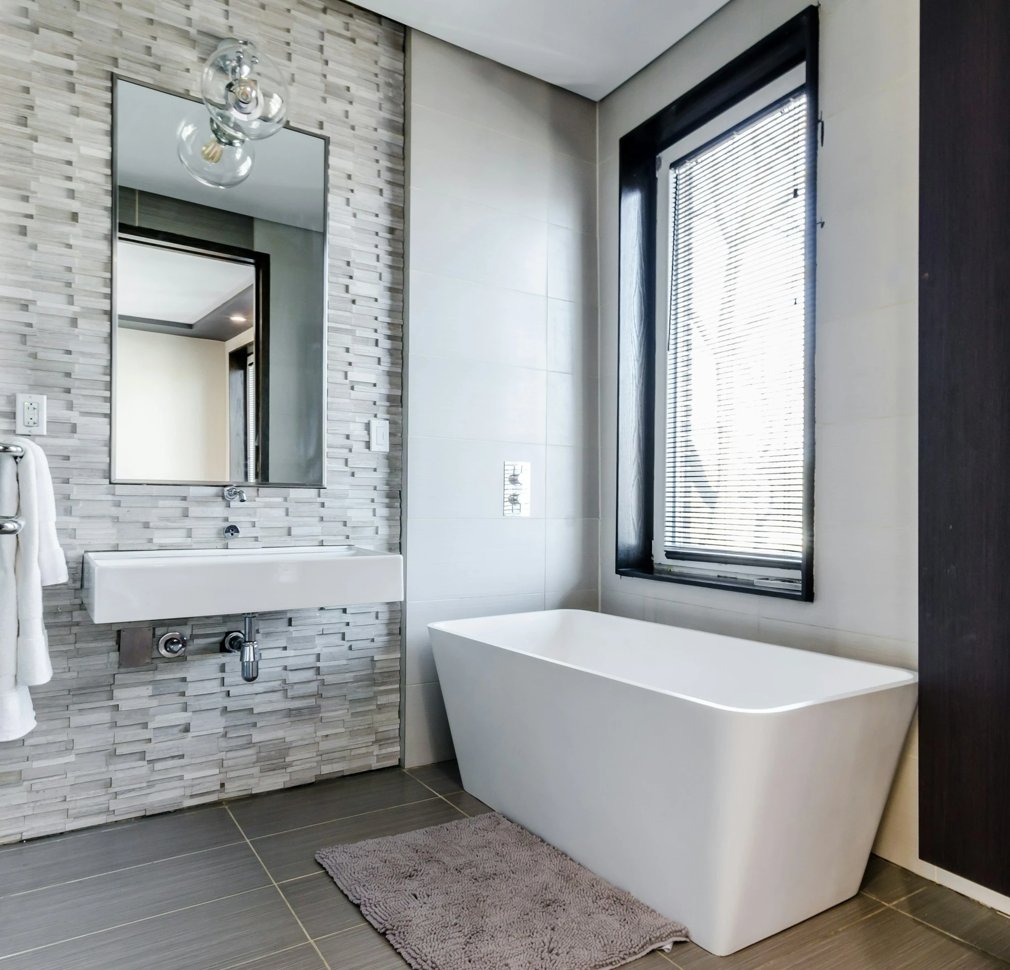 Bathroom with a freestanding tub beside a window