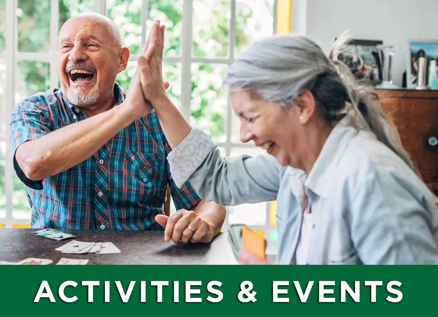 Image of two adult seniors playing cards with a link to the Activities and Events page for more information