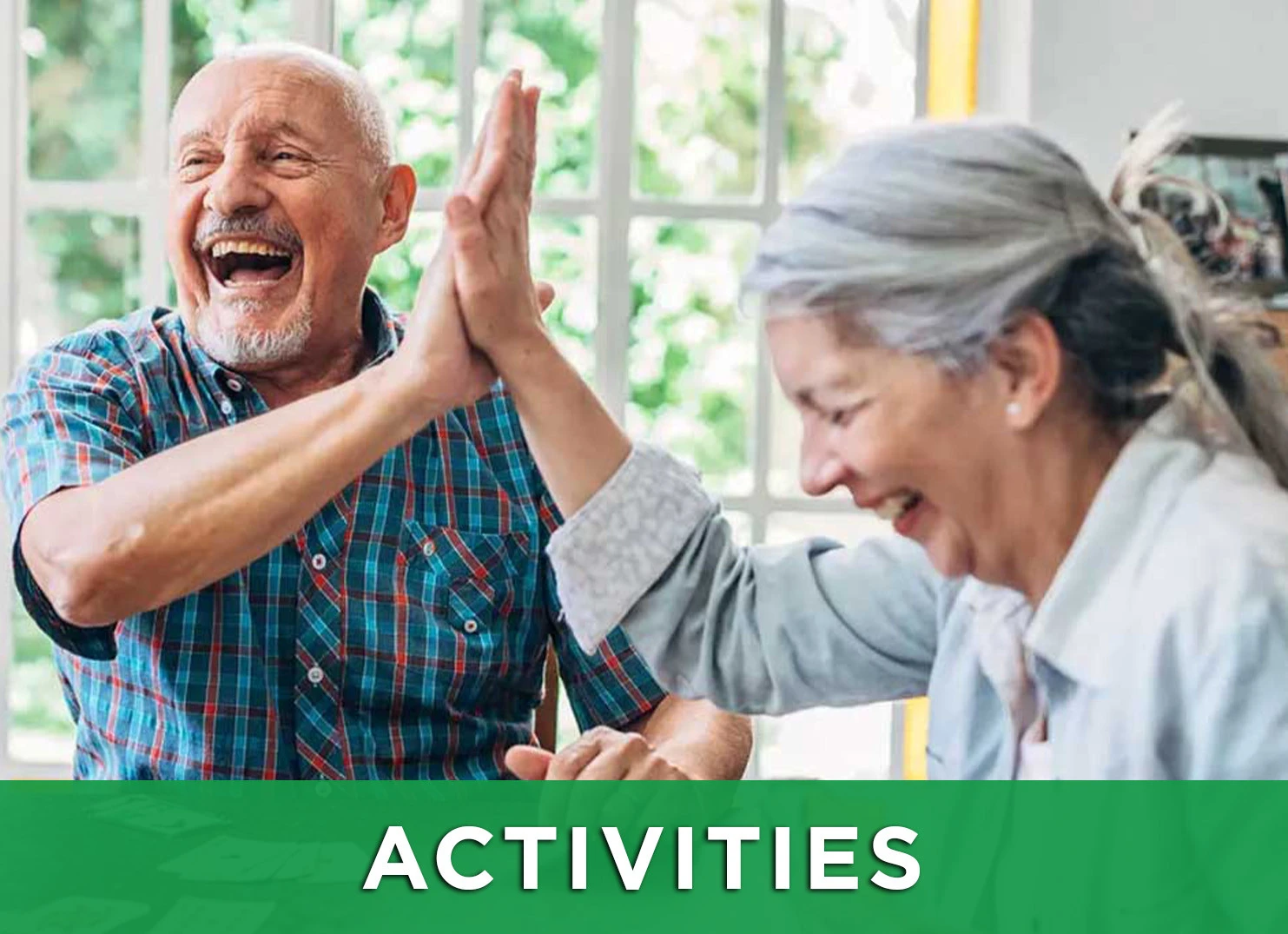 Image: Senior friends high five and play cards with a link to the Activities page for more information