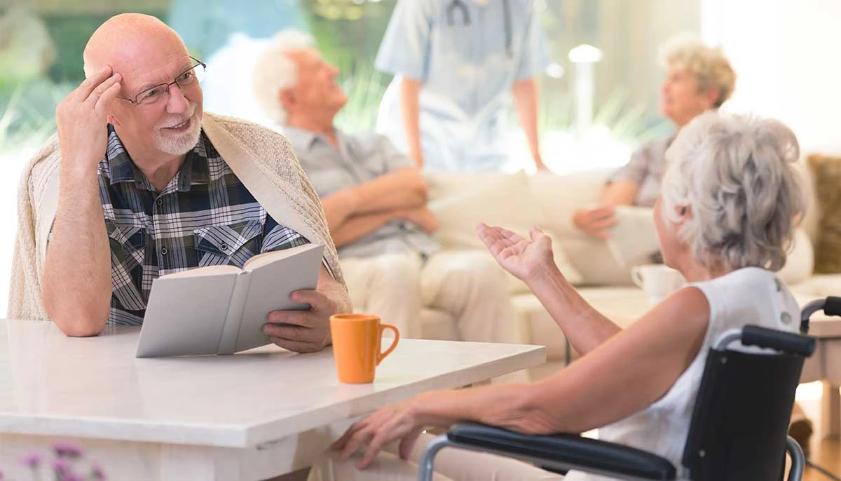 group of friends talking at an assisted living facility