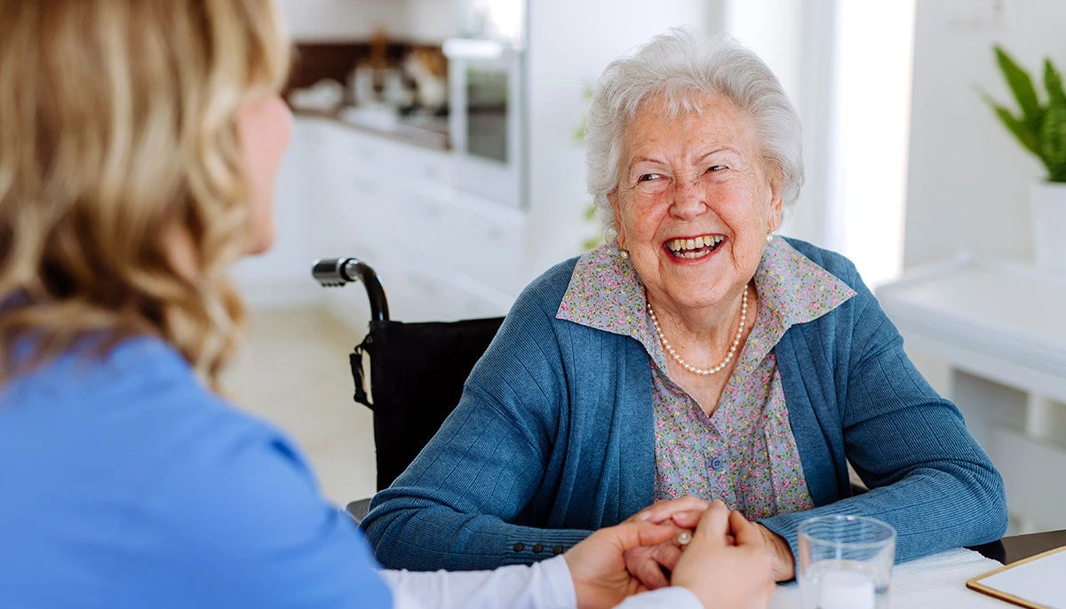 Image: Friends laughing and playing games at an assisted living facility