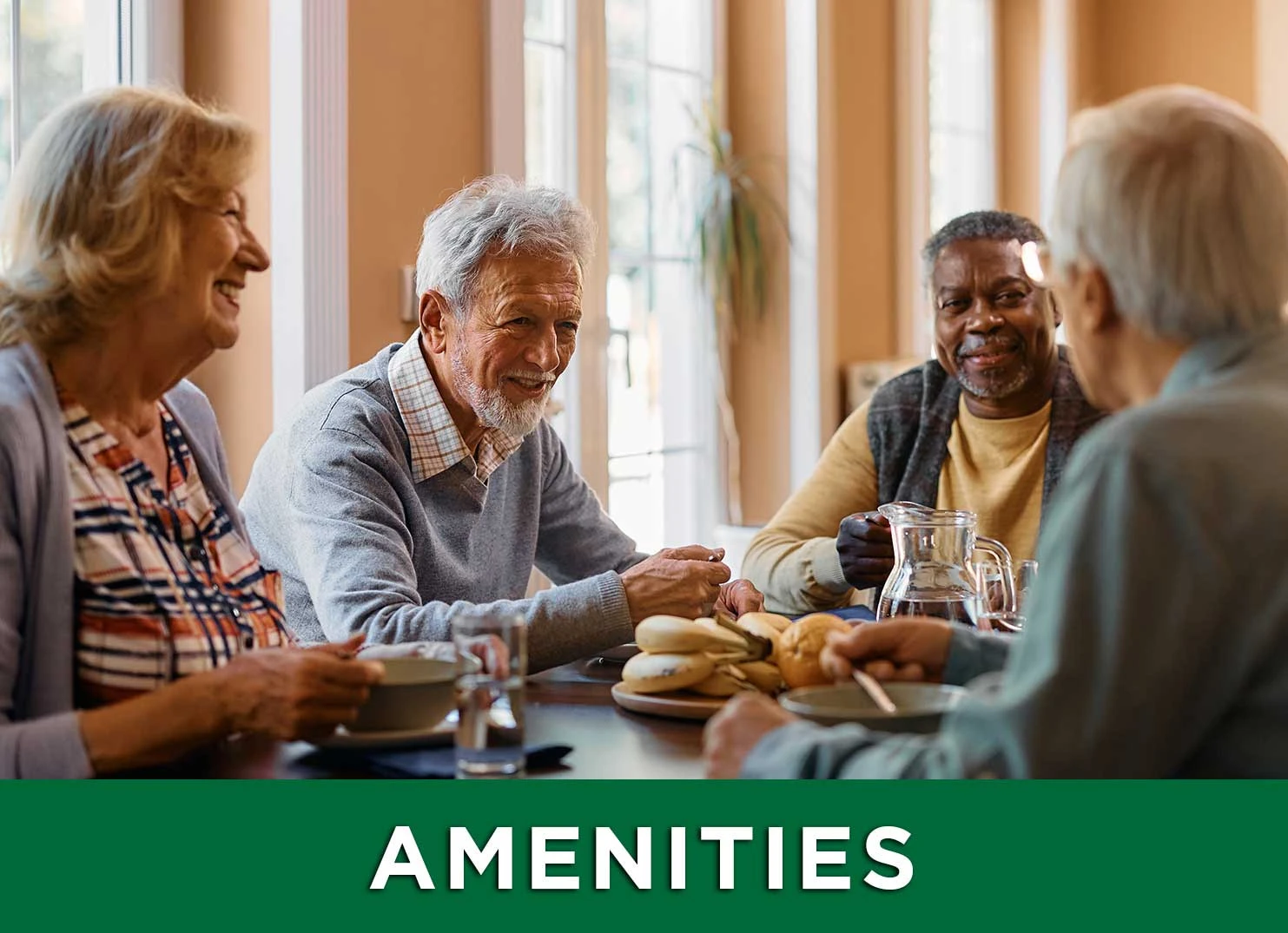 Group of senior friends sitting around a table enjoying breakfast and conversation