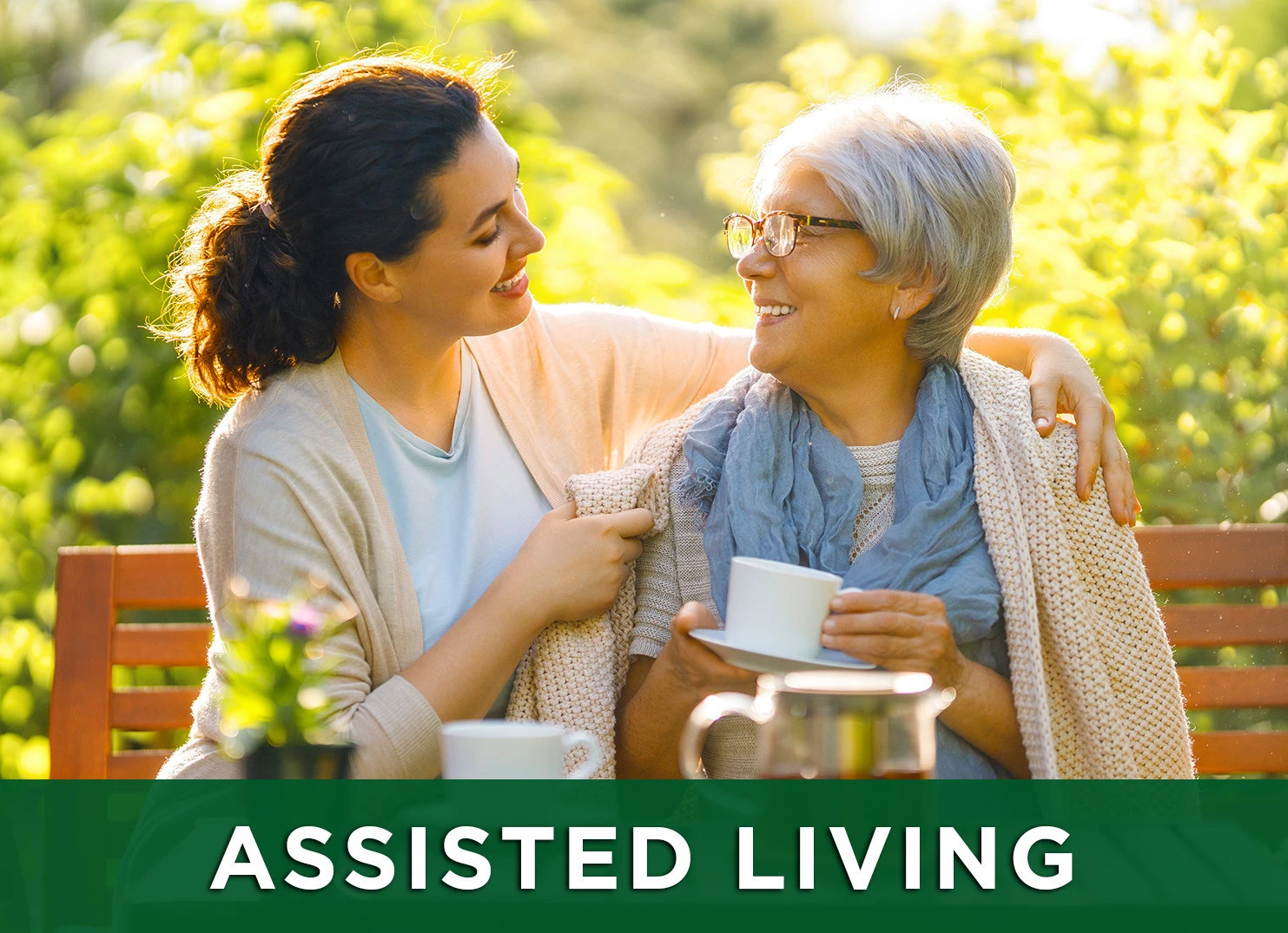 Image: Senior woman and her daughter drinking tea on a park bench; Link to assisted living page
