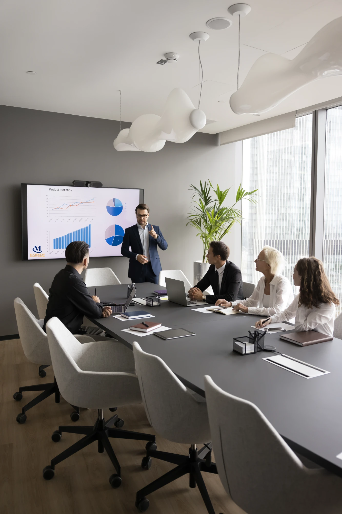 Image of people in a boardroom watching a Mainstay Financial Services presentation