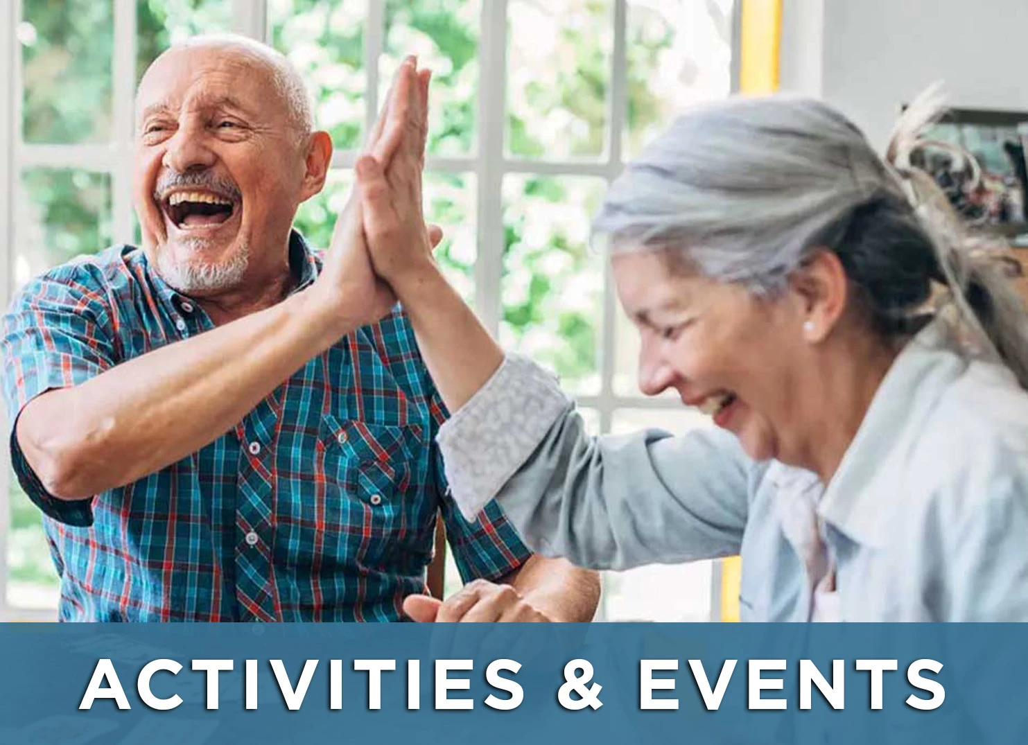 Image of older man and woman high five while playing a game with a link to the Activities &amp; Events page for more information