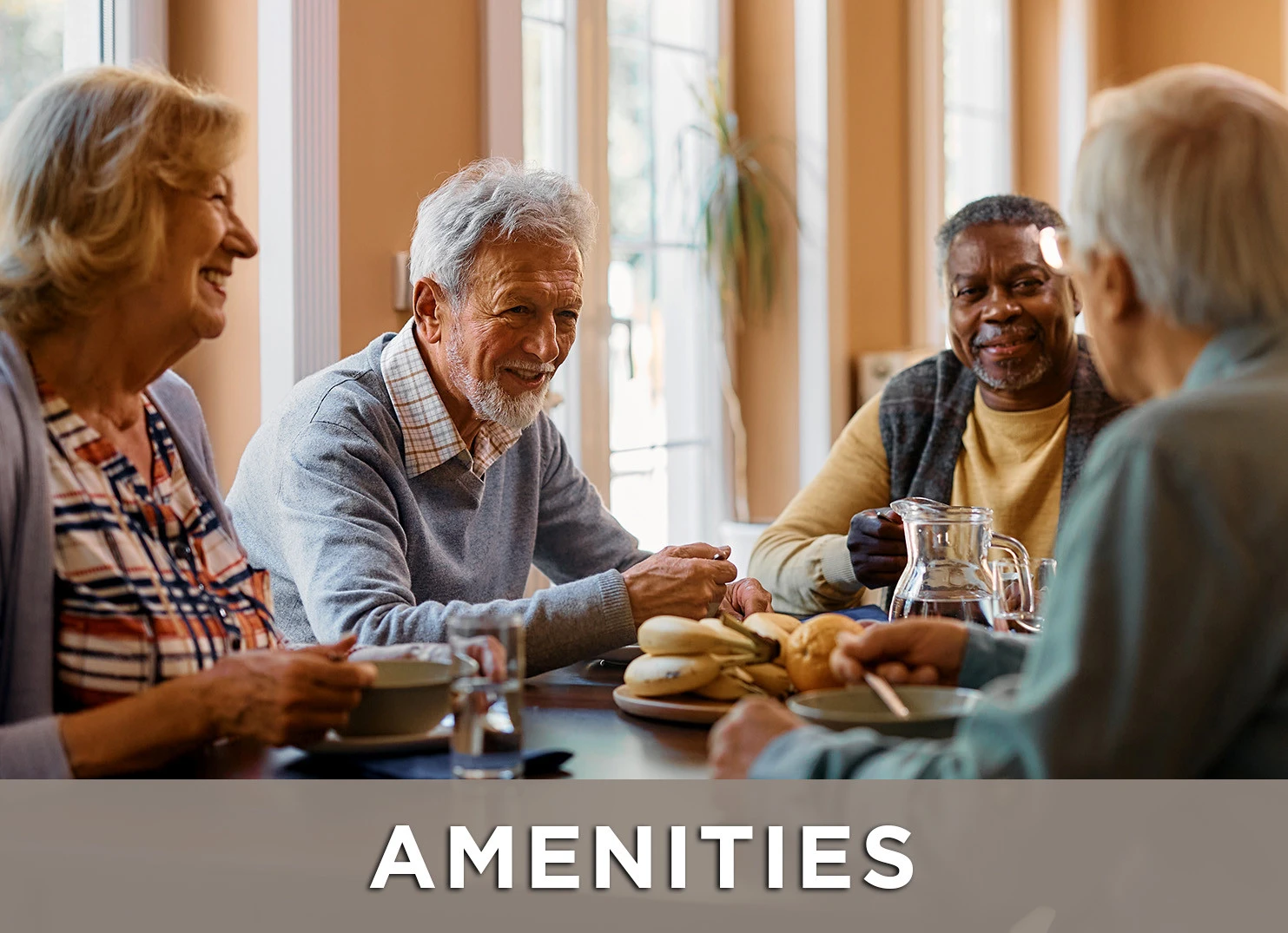 Image: Group of senior friends sitting around a table enjoying breakfast and conversation with a link to the amenities webpage