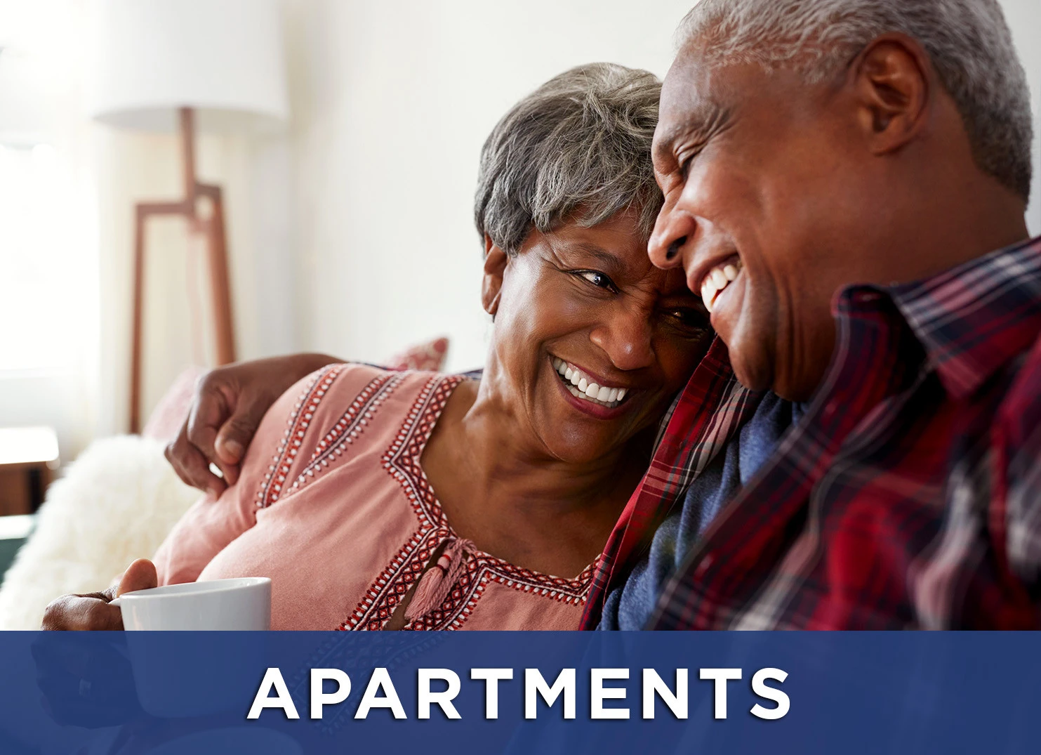 Image: Senior man and woman smiling with a link to Apartment page