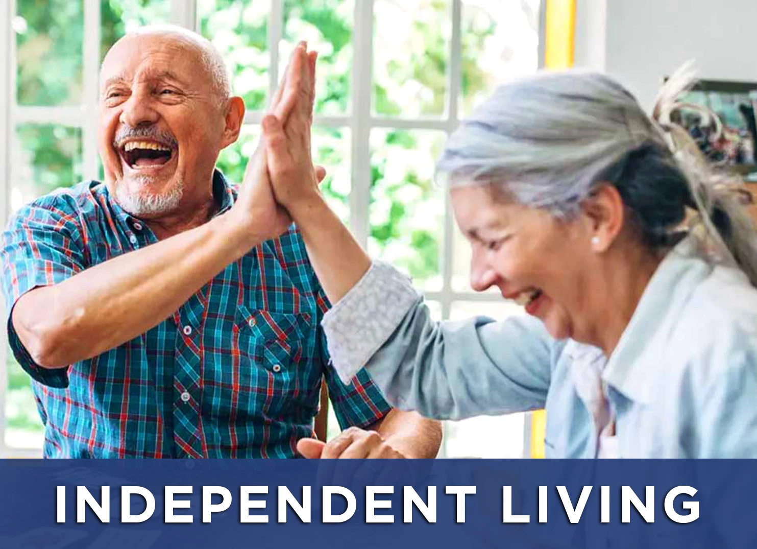 Image: Senior man and woman high five over a game with a link to learn more about independent living