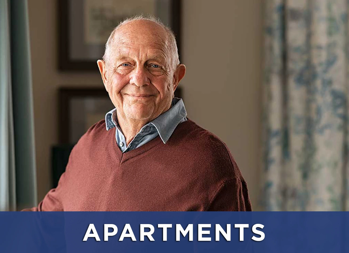 Image: senior man standing in apartment with a link to the apartments page for more information