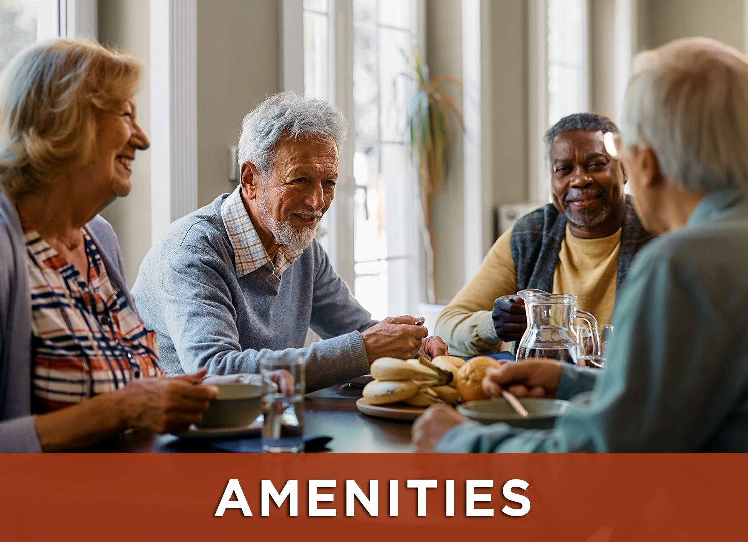 Image: Group of senior friends sitting around a table enjoying breakfast and conversation with a link to amenities webpage