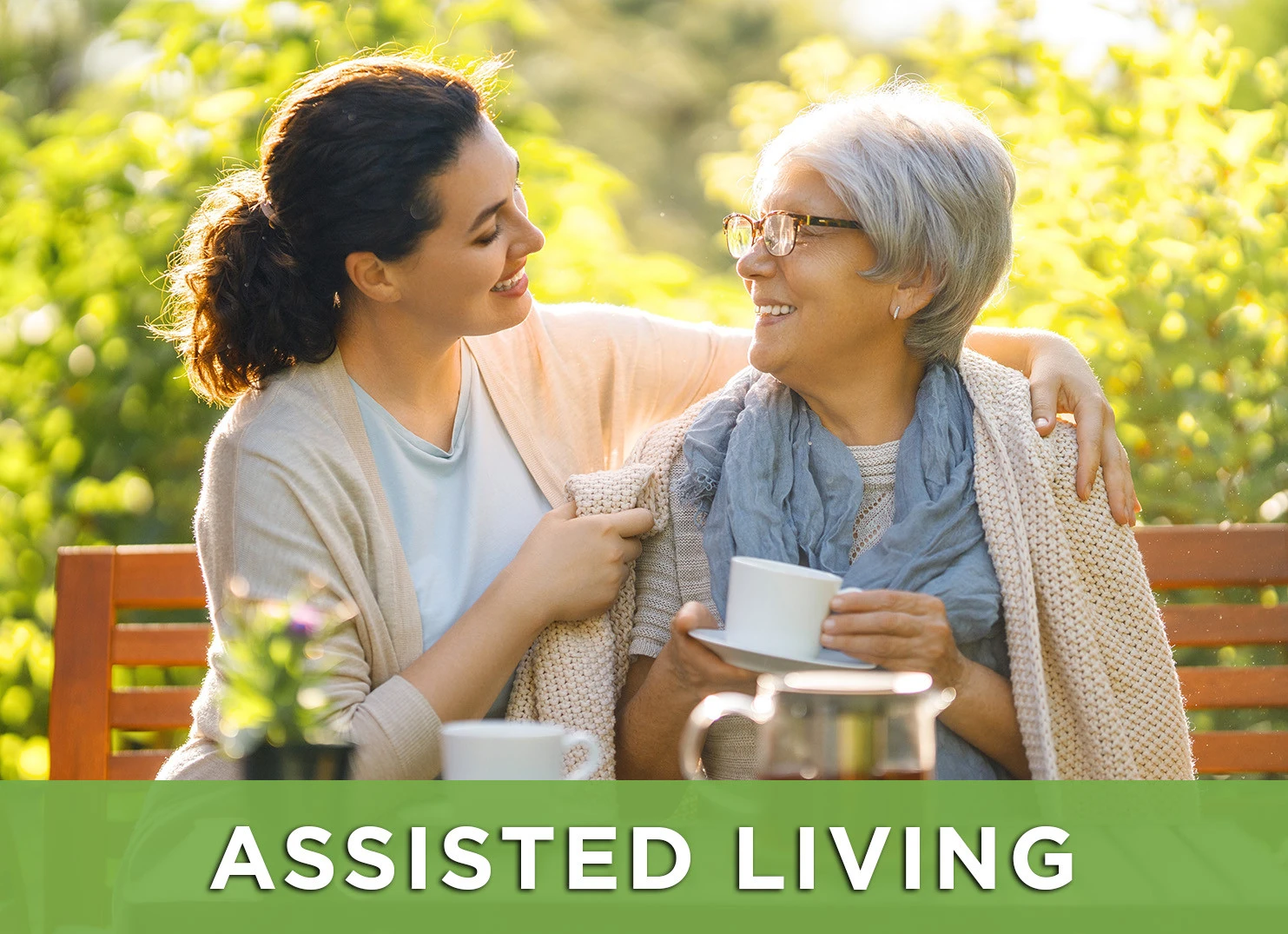 Image of senior woman and daughter on a park bench with a link to the Assisted Living page for more information