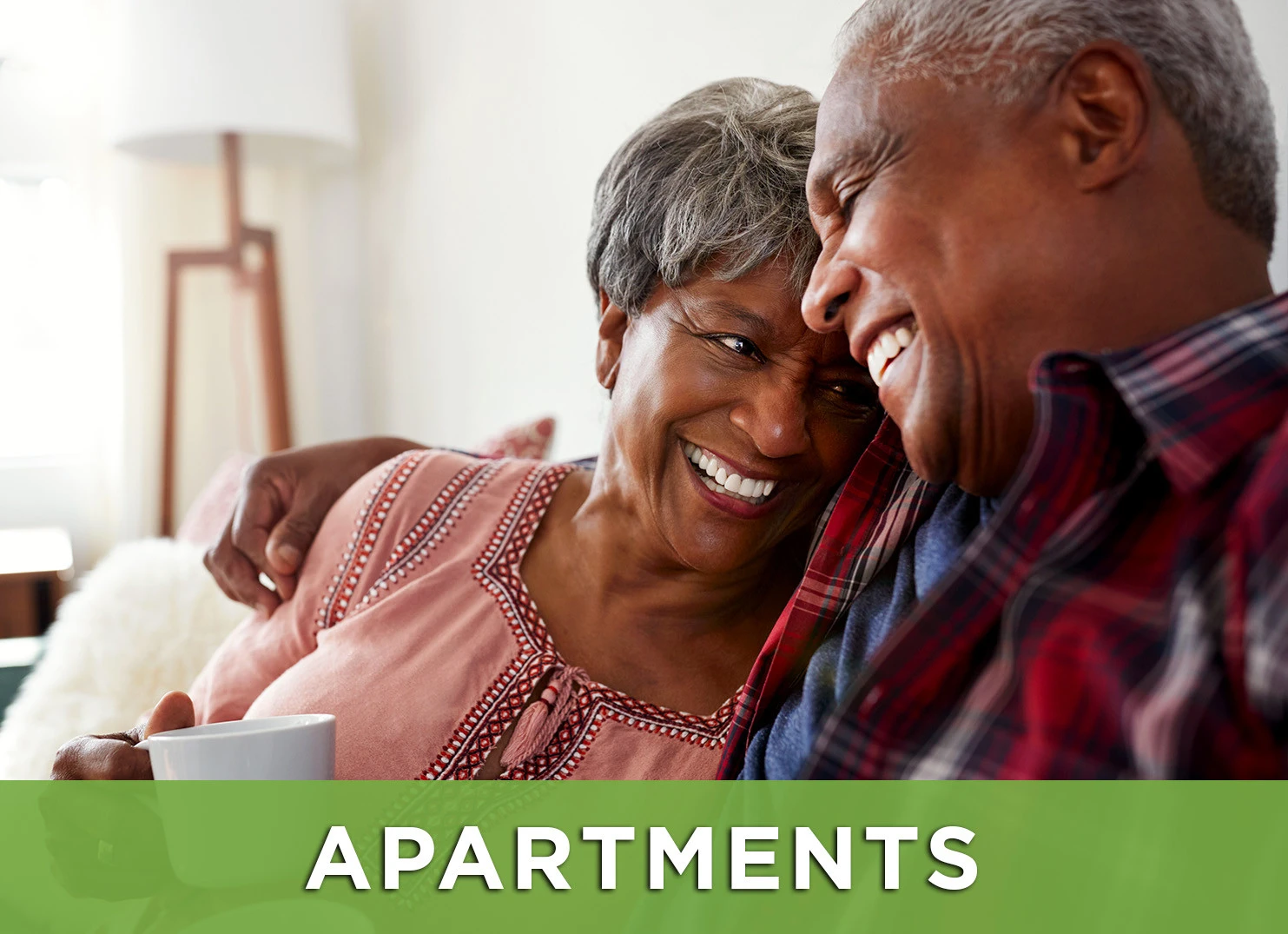 Image: Senior man and woman smiling with a link to the Apartments page