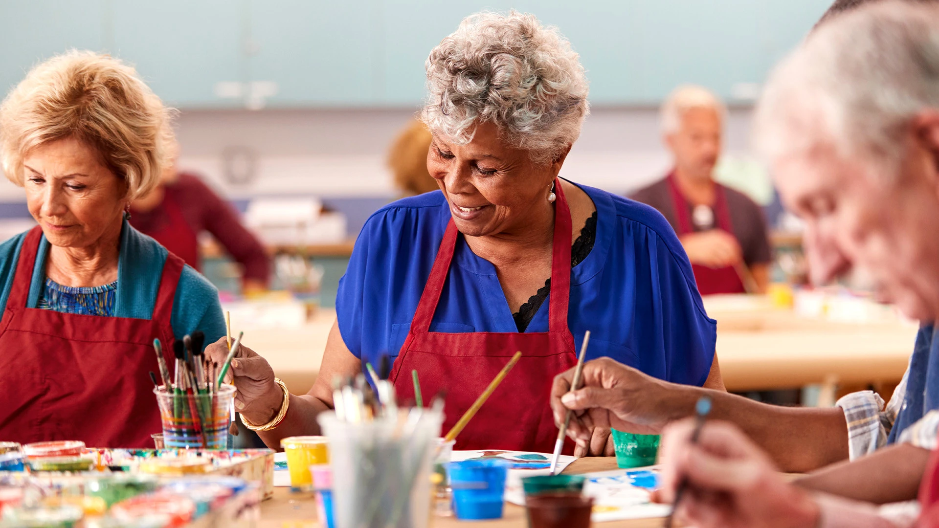 Two senior friends playing cards and laughing at assisted living community
