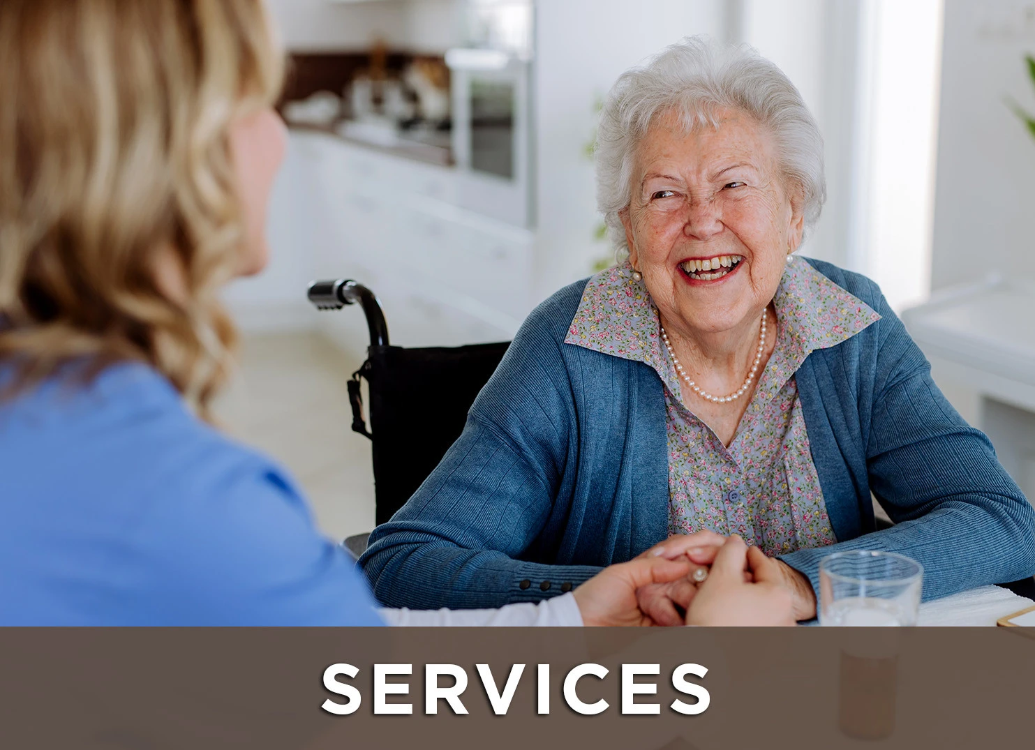 Image of senior woman in wheelchair smiling and talking to nurse with a link to the services page