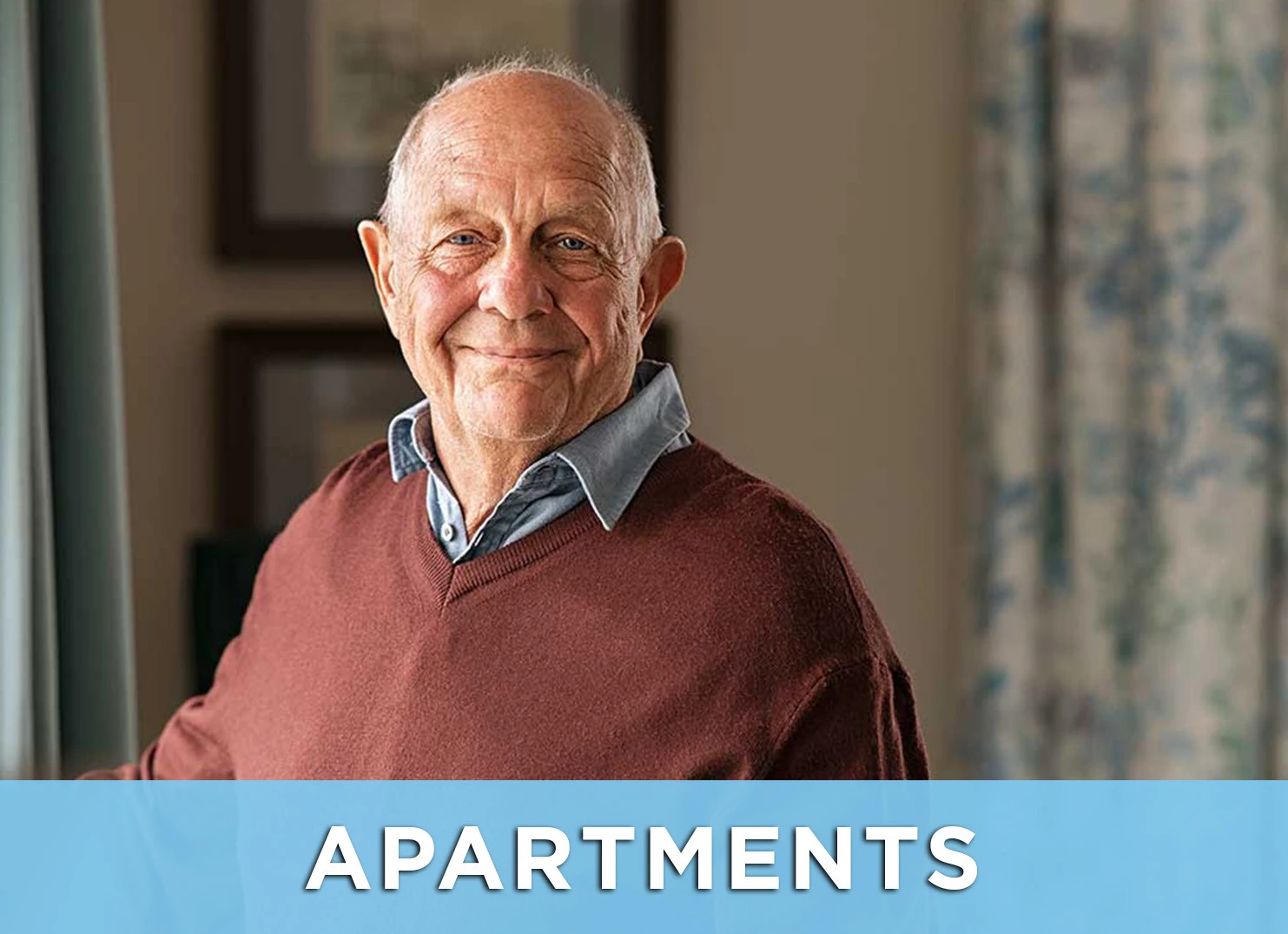 Image: Senior man smiling inside apartment; Link to Apartments page