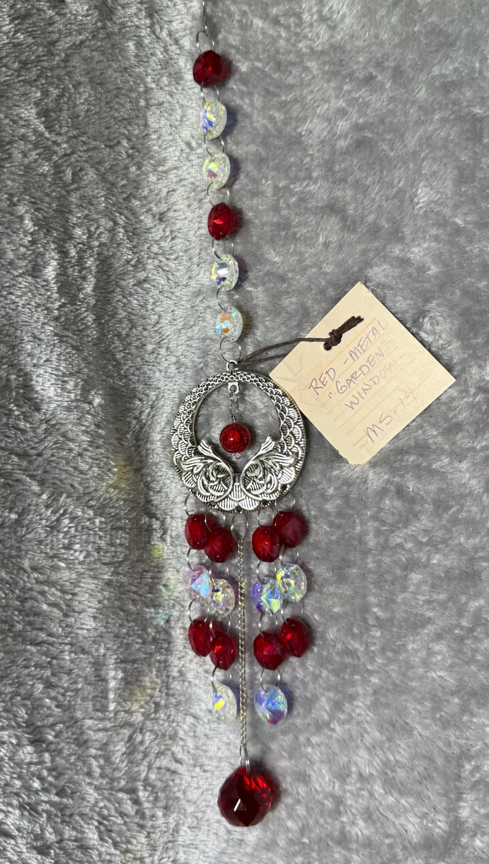 item METAL GARDEN WINDOW: Silver round garden window with flowers, red, clear beads, round red pendant, approx 2 1/2” wide 10” long ms-14.webp